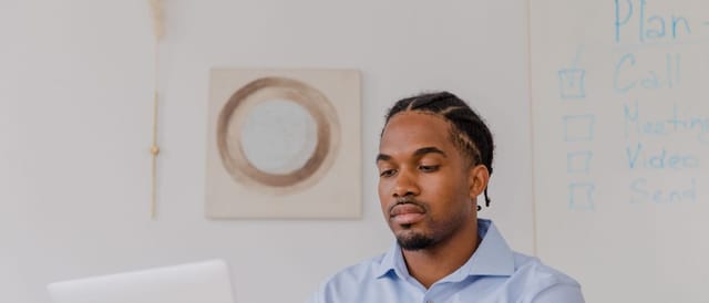 Professional working at a laptop in a bright office
