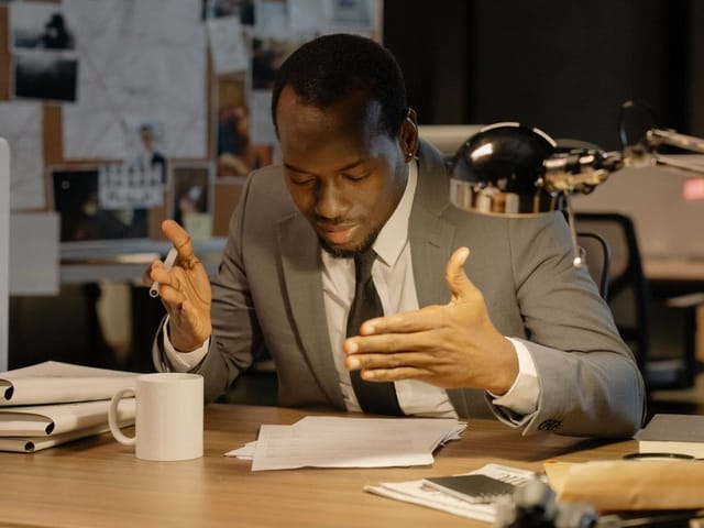 Government official reviewing documents at his desk