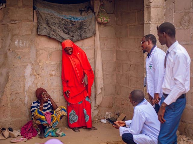 Health workers talking with residents during a visit to a rural community in Gombe, Nigeria