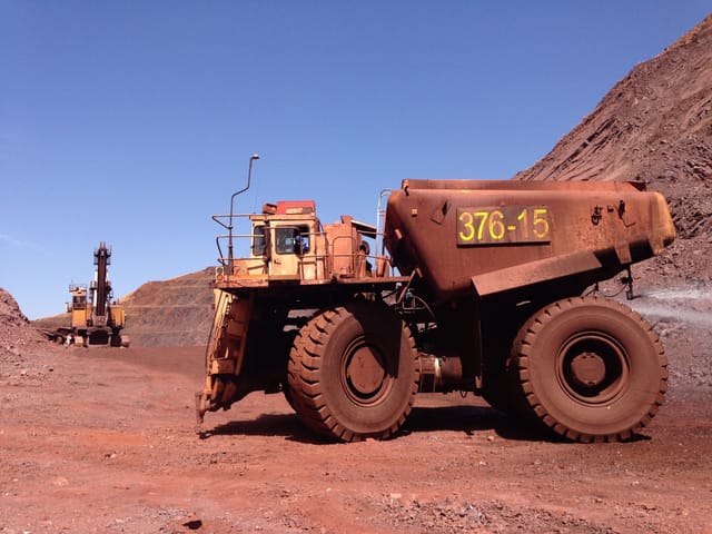 Large haul truck on red earth at an open-pit mine in South Africa