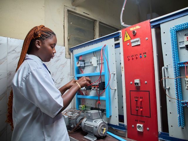 Technician wiring an electrical control panel