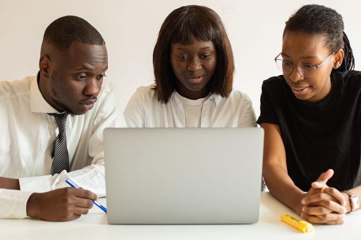 Bank staff reviewing figures together at a laptop